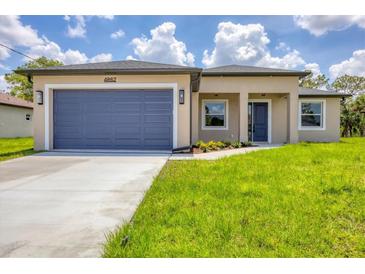 Charming single-story home with a well-manicured lawn, attached garage, and inviting entrance at 4862 Kiska Rd, North Port, FL 34288