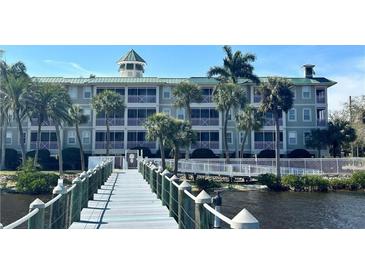Beautiful condominium complex with waterfront access and a wooden walkway to the building at 5114 Melbourne St # A302, Punta Gorda, FL 33980