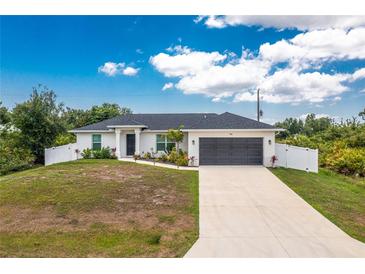 Charming single-story home showcasing a well-manicured lawn, two-car garage and a welcoming front entrance at 5532 Veracruz Ter, Port Charlotte, FL 33981