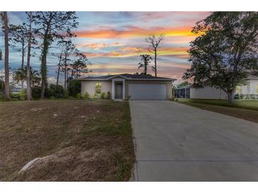 Charming single-story home with a well-manicured lawn, complemented by a spacious driveway and an attached two-car garage at 3799 Laredo Ave, North Port, FL 34288