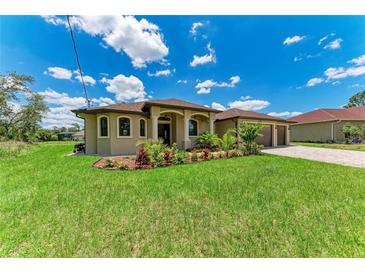 Charming single-Gathering home with a well-manicured lawn and tropical landscaping at 4380 Maddock Cir, North Port, FL 34286