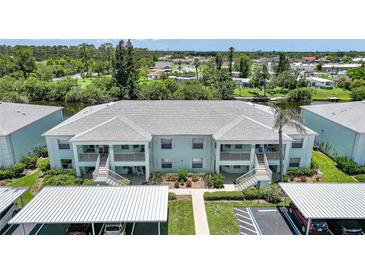 Lovely two-story condo building with carports and beautiful landscaping near canal at 5725 Greenwood Ave # 2101, North Port, FL 34287