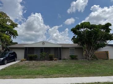 Charming one-story home featuring a screened entrance, attached garage, and a well-manicured front yard at 8158 Trionfo Ave, North Port, FL 34287