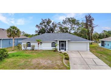 Well-maintained single-story home featuring a screened entry and attached two-car garage at 1210 Mccrory St, North Port, FL 34286