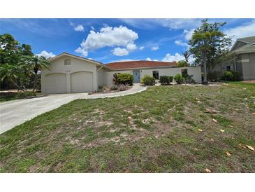 Charming single-story home with a well-maintained lawn and two-car garage at 1318 San Mateo Dr, Punta Gorda, FL 33950