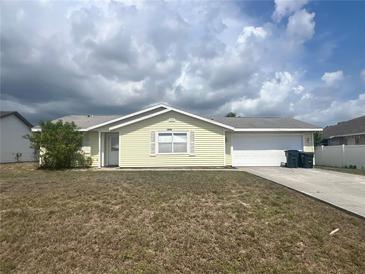 Charming single-story home with attached garage, neat landscaping, and inviting curb appeal at 2696 Gisela Rd, North Port, FL 34287