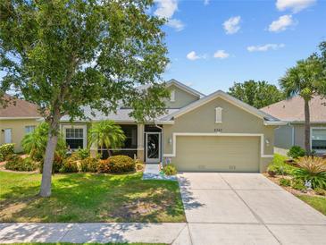 Charming single-story home featuring a two-car garage and lush landscaping, creating a welcoming curb appeal at 2747 Suncoast Lakes Blvd, Punta Gorda, FL 33980