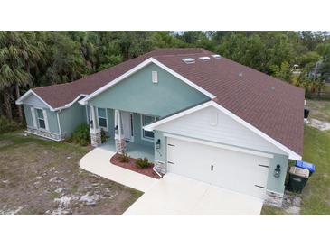 Charming single-Gathering home featuring a well-maintained yard, covered entryway, and attached two-car garage at 2858 Parlay Ln, North Port, FL 34286