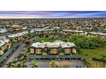 Wide aerial view of the condominium complex showcasing the neighborhood with canals and lush landscaping at 601 Shreve St # 64C, Punta Gorda, FL 33950