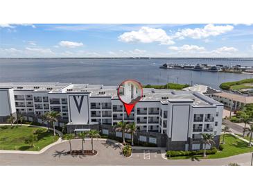 Stunning waterfront condo building with lush landscaping, offering breathtaking coastal views at 1425 Park Beach Cir # 1310, Punta Gorda, FL 33950