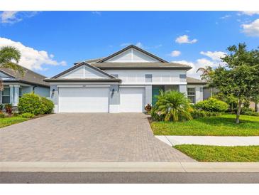 Charming two-story home with a three-car garage and a beautifully landscaped front yard at 19821 Montenero Way, Venice, FL 34293