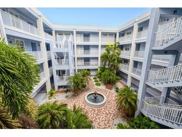 Three story courtyard with a fountain, decorative brick, and stairs to each floor at 2001 Bal Harbor Blvd # 2306, Punta Gorda, FL 33950