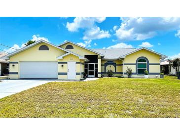Charming one-story home featuring a well-maintained lawn and attached two-car garage at 2399 Bendway Dr, Port Charlotte, FL 33948