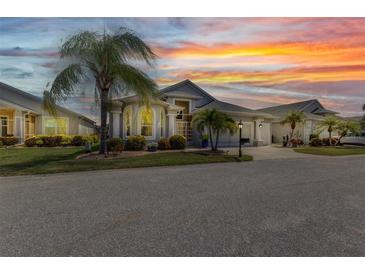 Charming home with a well-manicured lawn, tropical landscaping, and inviting curb appeal at 24358 Folkstone Ave, Punta Gorda, FL 33980