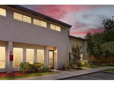 Charming two-story townhome with a well-manicured lawn and beautiful landscaping at dusk at 4346 Rayfield Dr # 4346, Sarasota, FL 34243