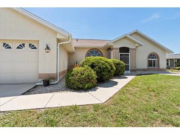 Charming single-story home features a well-maintained lawn and beautiful landscaping at 7334 N Tulip Tree, Punta Gorda, FL 33955