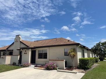 Charming condo featuring a stucco exterior, well-maintained landscaping, and neutral tones at 13100 S Mccall Rd # 125, Port Charlotte, FL 33981