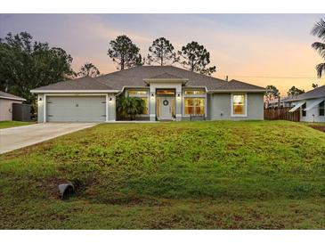 Charming single-story home featuring a well-manicured lawn and a welcoming front entrance at 5436 Jessamine Ave, North Port, FL 34291