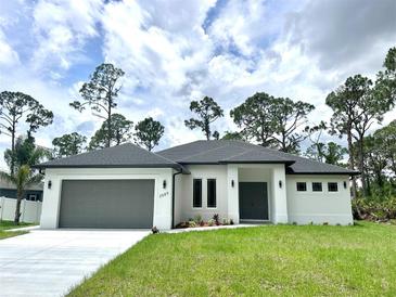 Beautiful one-story home with a well-manicured lawn and attached two-car garage at 2089 Garnet St, North Port, FL 34288