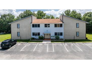 Charming condo building exterior features a well-maintained facade and ample parking spaces at 22481 Westchester Blvd # B48, Punta Gorda, FL 33980
