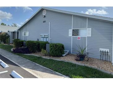 Charming condo featuring a well-maintained exterior with manicured landscaping and neutral-colored siding at 3300 Loveland Blvd # 602, Punta Gorda, FL 33980