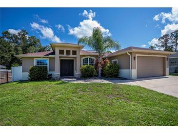 Charming single Gathering home featuring a well-manicured lawn and a two-car garage at 4294 Wooley Ave, North Port, FL 34287