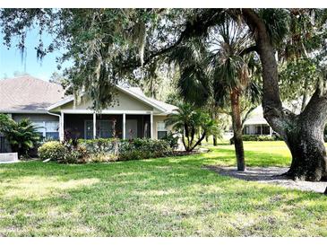 Charming single-story home with screened porch, mature trees, and well-maintained landscaping at 1431 Red Oak Ln, Port Charlotte, FL 33948