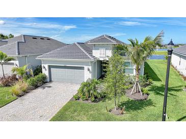 Beautiful exterior view of the home, featuring a gray roof, a driveway, and landscaping at 15039 Black Cherry Way, Punta Gorda, FL 33955