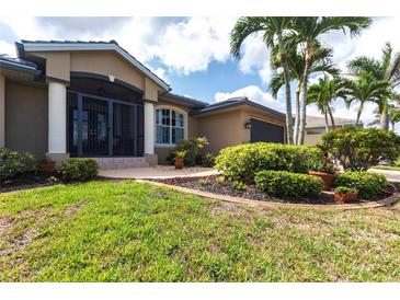 Charming single-story home featuring a tile roof, manicured lawn, and a welcoming front entrance at 17150 Sarong Ln, Punta Gorda, FL 33955