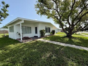 Charming single-story home featuring a lush lawn and mature shade trees at 21899 Cellini Ave, Port Charlotte, FL 33952