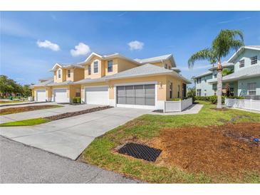 Inviting yellow townhomes featuring attached garages and well-maintained landscaping, offering a comfortable and stylish living environment at 25555 Heritage Lake Blvd # 27, Punta Gorda, FL 33983