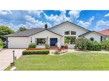 Charming single Gathering home with manicured lawn, flower beds, and dark tile roof at 3724 Bordeaux Dr, Punta Gorda, FL 33950