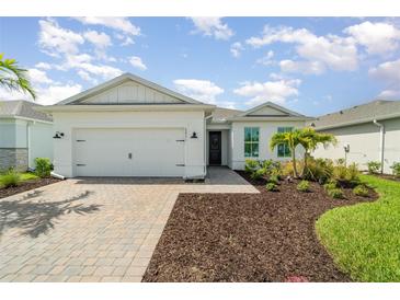 Charming single-story home with a two-car garage, manicured landscaping, and a welcoming entrance at 42771 Valley Brooks St, Punta Gorda, FL 33982