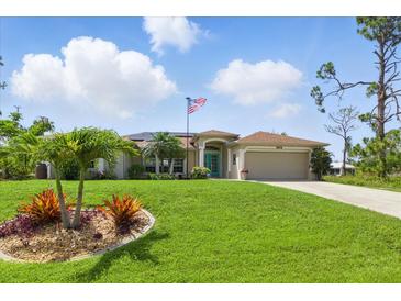 Well-maintained lawn and landscaping in front of this charming single-story home at 5273 Crestline Ter, Port Charlotte, FL 33981