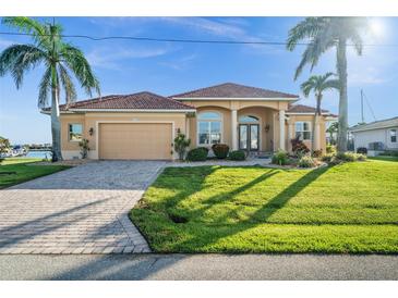 Beautiful single-story home with a tile roof, well-kept lawn, and tasteful landscaping at 3322 Sandpiper Dr, Punta Gorda, FL 33950