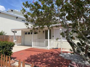 Charming home featuring a brick front porch and well-maintained landscaping at 617 W Olympia Ave, Punta Gorda, FL 33950