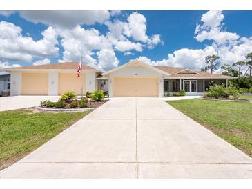 Charming single Gathering home featuring a wide driveway and beautifully landscaped front yard at 871 Columbia St, Port Charlotte, FL 33948