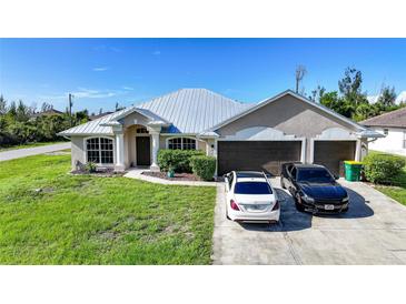 Charming single-story home with a well-maintained lawn and a three-car garage at 15117 Lyneburg Ave, Port Charlotte, FL 33981