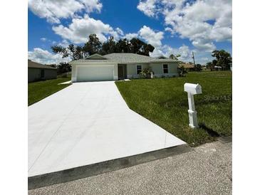 Charming single-story home featuring a well-maintained lawn and a paved driveway leading to an attached garage at 16403 Perdida Ct, Punta Gorda, FL 33955