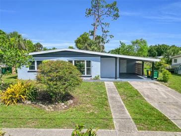 Charming single-story home featuring a covered carport and a well-maintained front yard at 22219 Catherine Ave, Port Charlotte, FL 33952