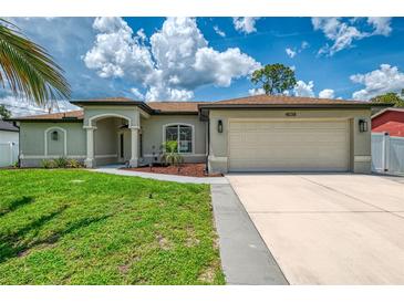 Charming single-story home with a well-manicured lawn, complemented by an attached two-car garage and neutral color palette at 4038 Corydon Ave, North Port, FL 34286