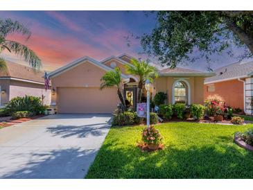 Charming single-story home with well-manicured lawn, mature trees and inviting curb appeal at 1775 Scarlett Ave, North Port, FL 34289