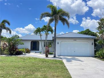 Charming home with well-manicured lawn and mature palm trees, showcasing curb appeal at 2526 Brazilia Ct, Punta Gorda, FL 33950