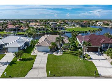 Expansive aerial view of waterfront homes with lush landscaping and private docks at 531 Madrid Blvd, Punta Gorda, FL 33950
