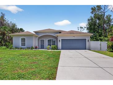 Charming single-story home with a well-manicured lawn and two car garage at 1762 Mincey Ter, North Port, FL 34286