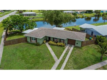 Charming single-story home featuring a well-maintained lawn, fenced yard, and convenient two-car garage at 21539 Gladis Ave, Port Charlotte, FL 33952