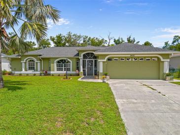 Charming single-story home with a well-manicured lawn and an attached two-car garage at 2455 Jacoby Cir, North Port, FL 34288