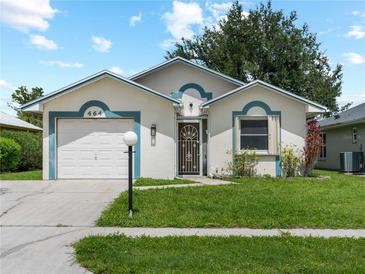 Charming single-story home with a well-manicured lawn and a white front door at 464 Rose Apple Cir, Port Charlotte, FL 33954