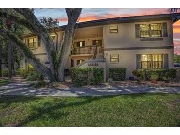 Condo exterior with lush landscaping, mature trees, and a serene setting at sunset at 19505 Quesada Ave # Tt101, Port Charlotte, FL 33948