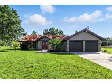 Charming single-story home featuring a well-manicured lawn and a two-car garage at 5052 Kingsley Rd, North Port, FL 34287